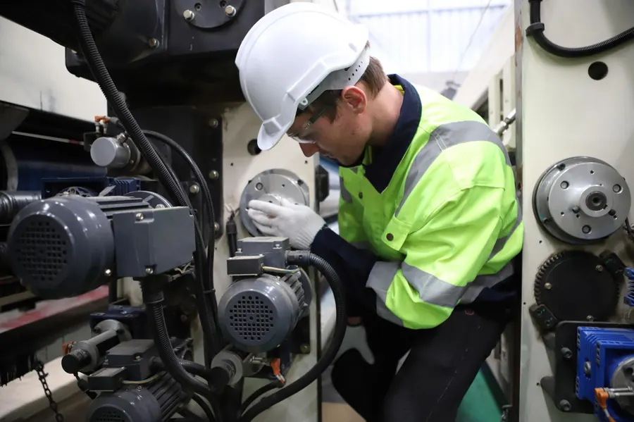 Engineer inspecting machinery on the shop floor